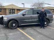 A photo of the newest police officer Nathan Coleman and his police car.