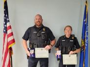 Lt. Lauren Moe and Officer Jared Wilson receive Lifesaving Awards citations and medals..