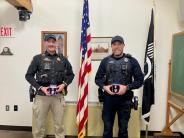 Photo of Deputy Steve Herbers on left and Officer Shawn Deneen on right receiving their Lifesaving Awards.