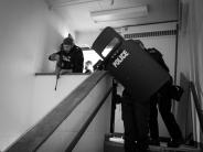 A photo of the Special Response Team (SRT) at training in an active shooter scenario in a stairwell.